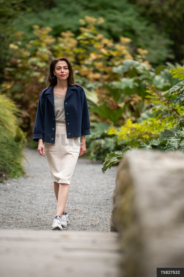 Woman with blue jacket in park