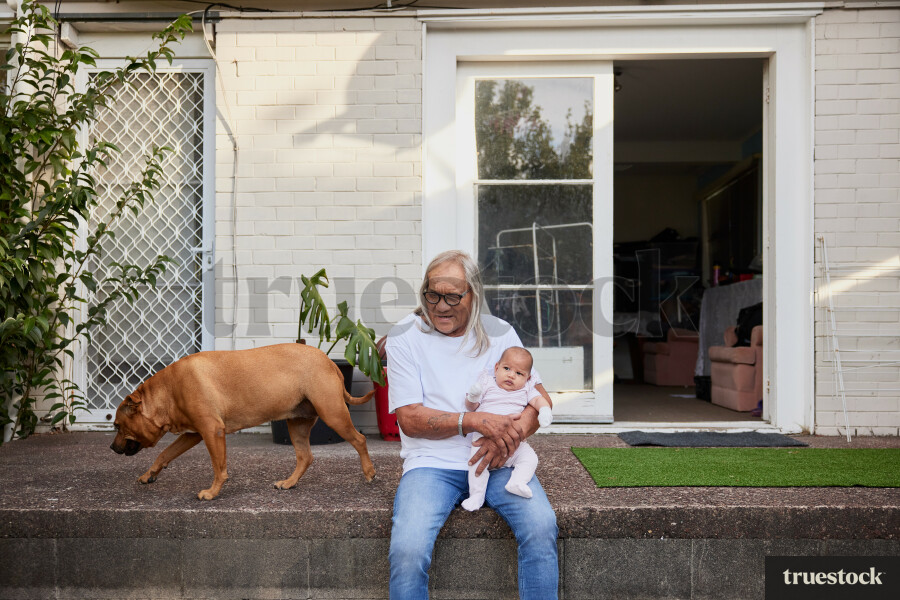 Grandfather Holding Granddaughter on Back Porch