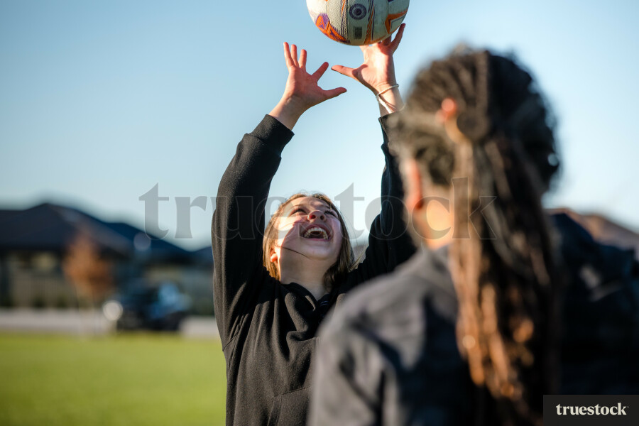 Dad Playing Catch with his Daughters