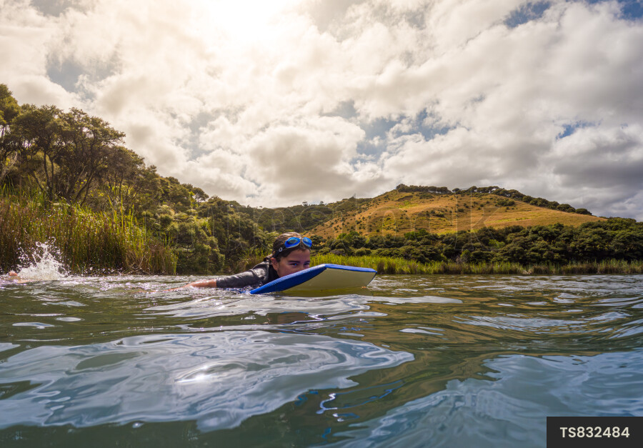 Girl swimming with boogie board