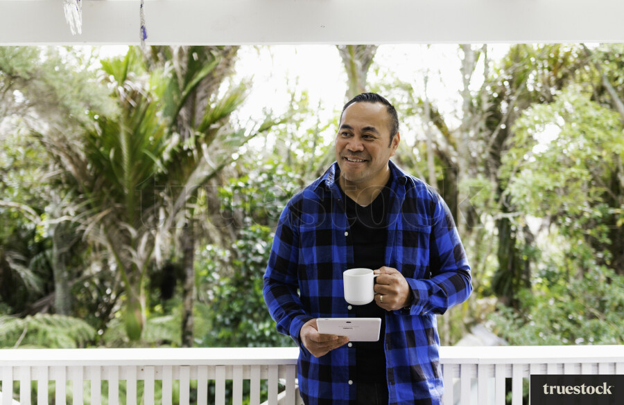 Samoan Man on Device with a Coffee