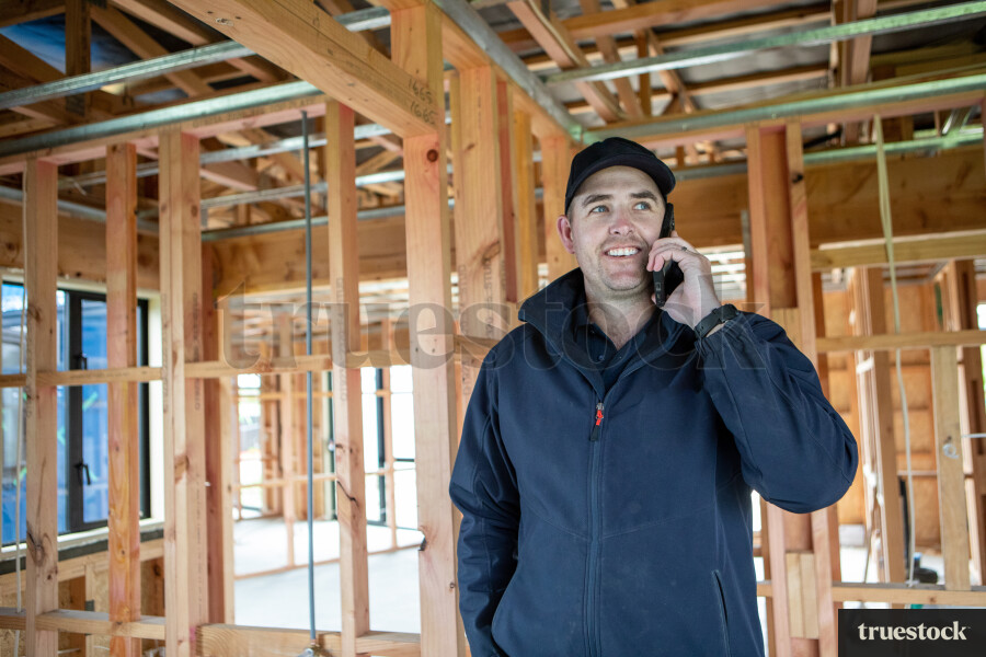 Electrician on Phone Call at Work