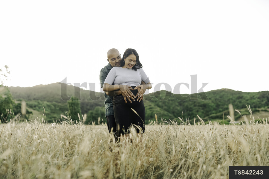 Husband and Pregnant Wife in Field