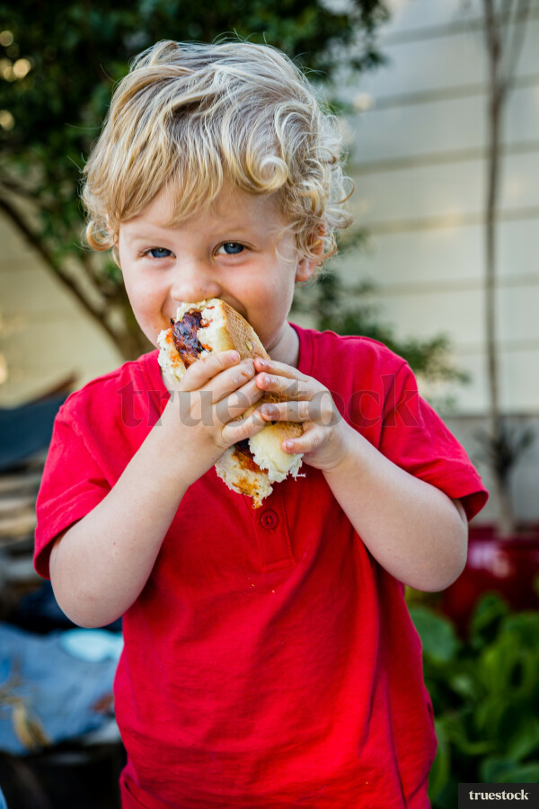 Toddler eating a sandwich