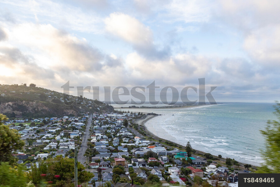 Residential suburb by coastline under clouds