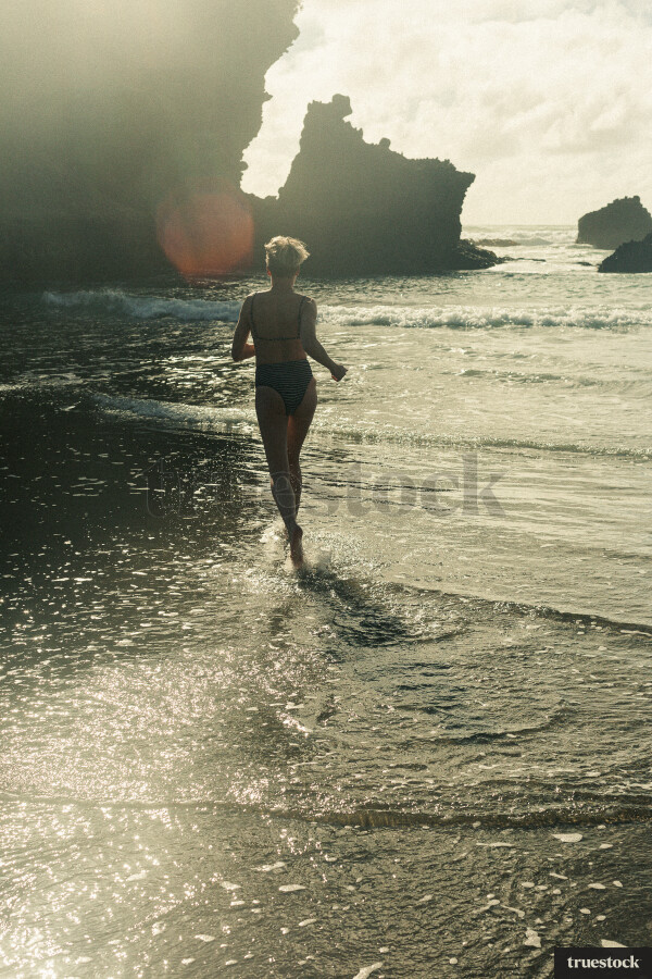 Woman Swimming at Piha Beach