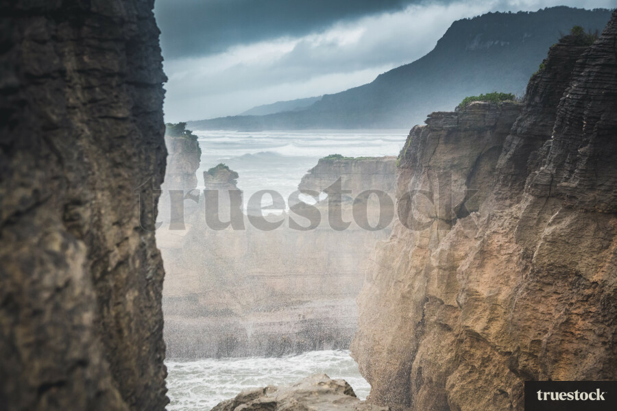 Landscape of rocky coast and ocean waves on an overcast day