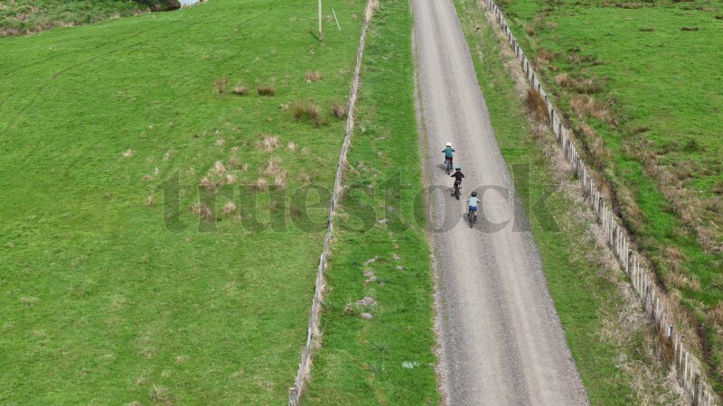 Aerial view of boys cycling on country road