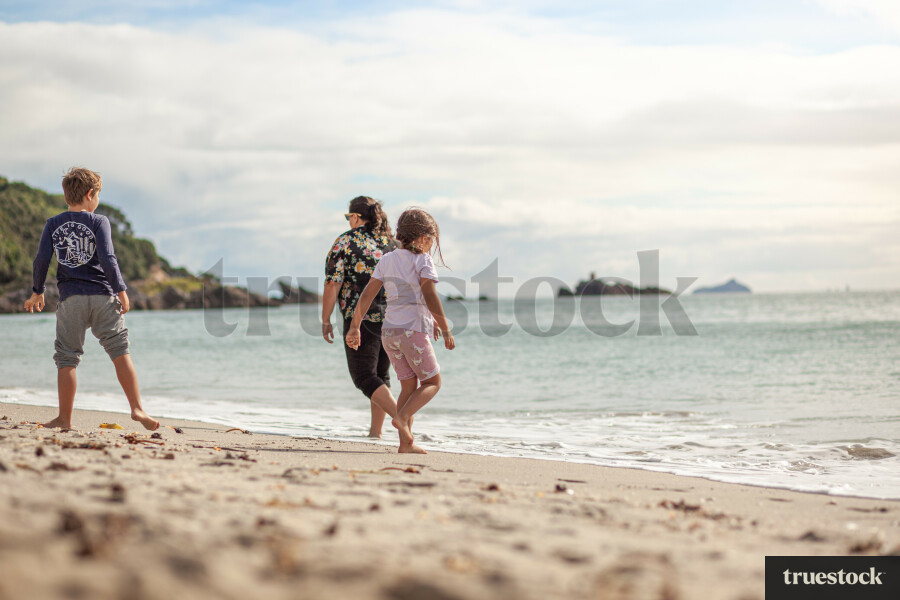 Mother and children on the sand at the beach