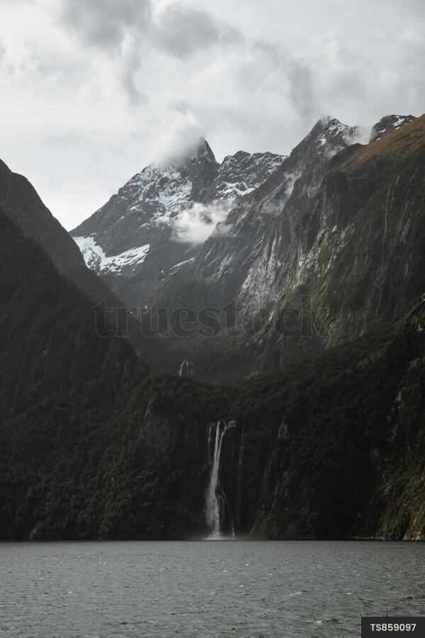 Scenic view of waterfall and mountains