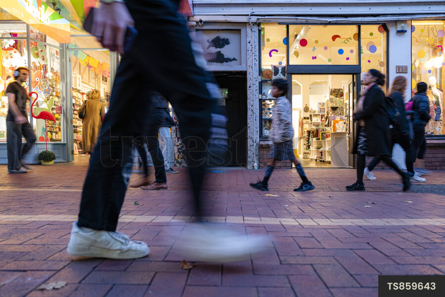 Commuters on streets outside stores