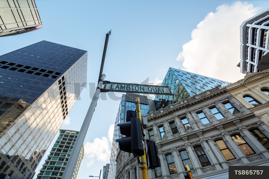 Urban scene of buildings and street sign from below