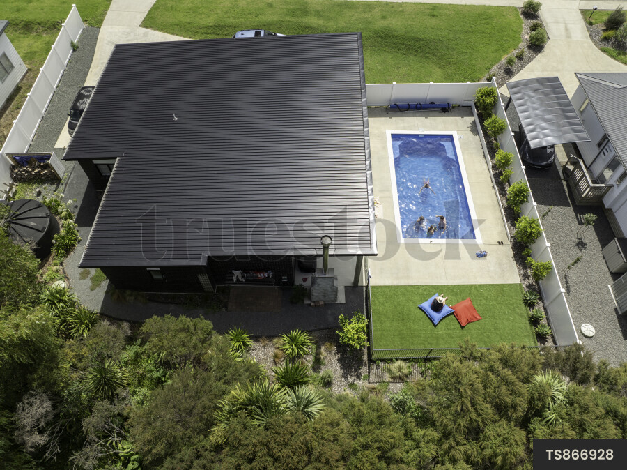 Drone view of family swimming in pool