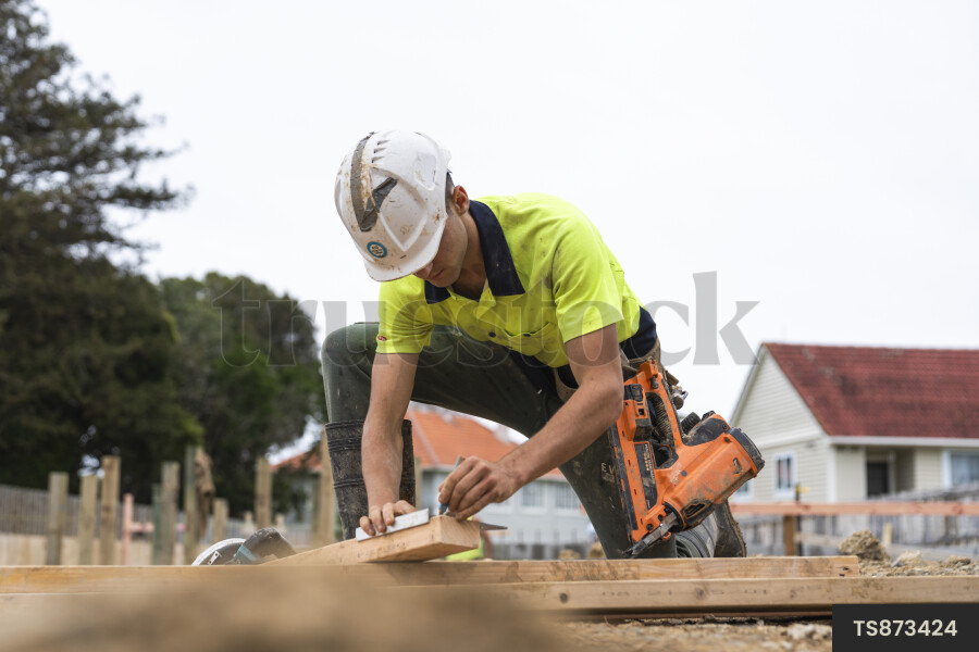 TS873424 Man working with power tools at construction site by Jeremy ...