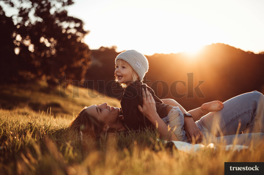 Mother Holding Daughter in Grass