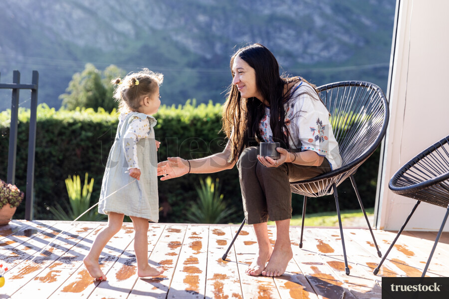 Young Girl Playing With Toy on Deck