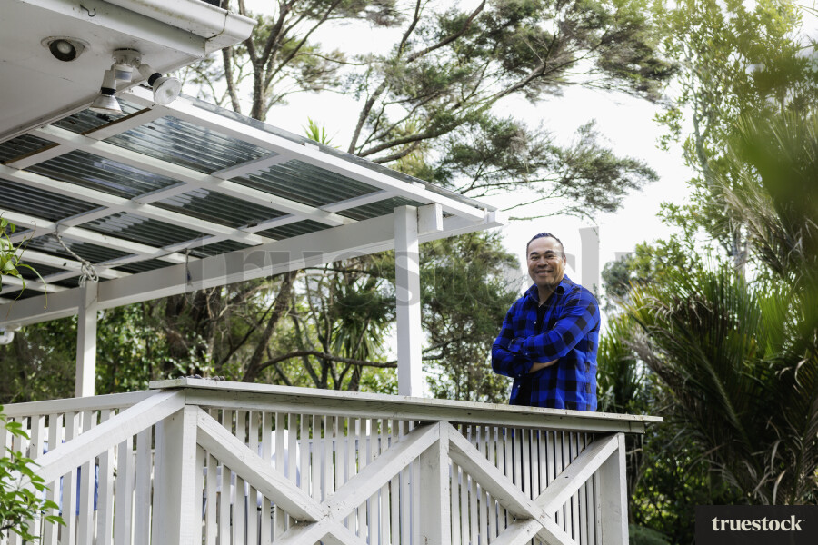 Samoan Man standing on Deck outside Home