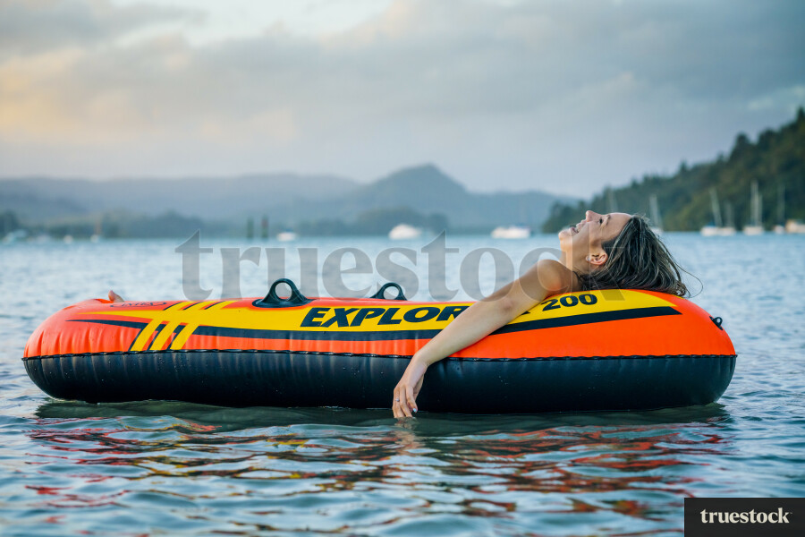 Woman Relaxing in an Inflatable Boat