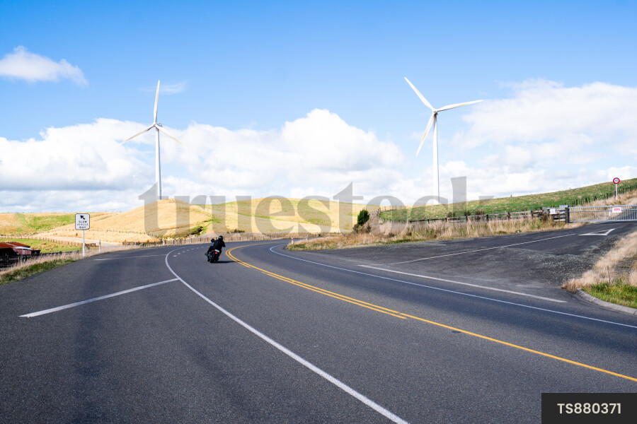 Man riding motorbike on road through countryside
