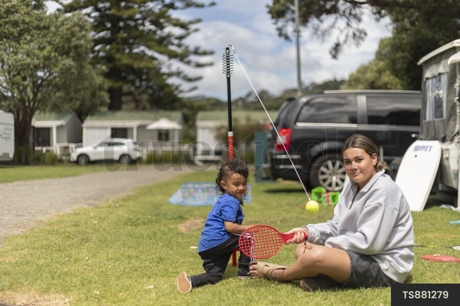 Girl playing with her brother at campground