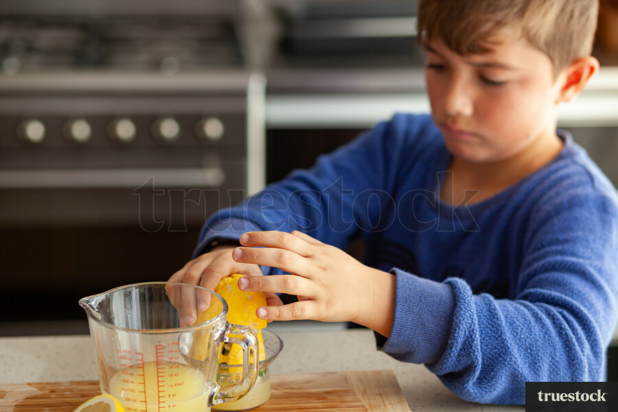 Young children making lemondade