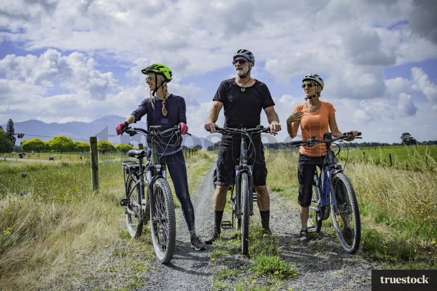 Cyclists By Farmland