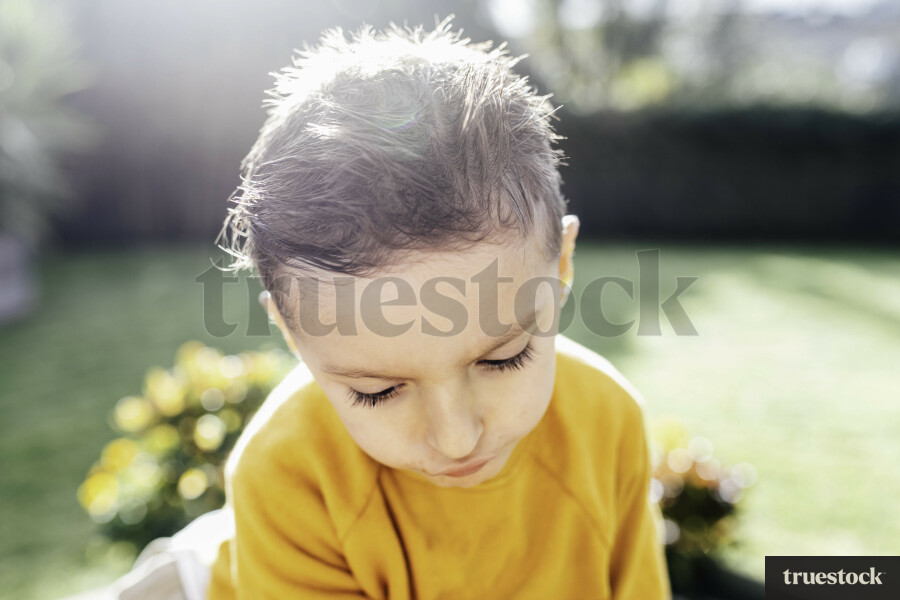 Young boy looking down