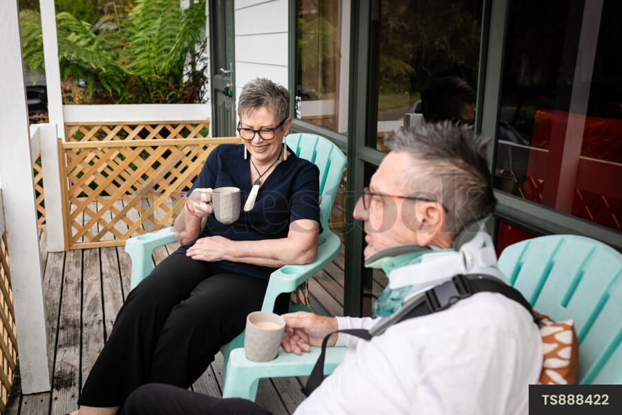 Health carer sitting with patient on deck
