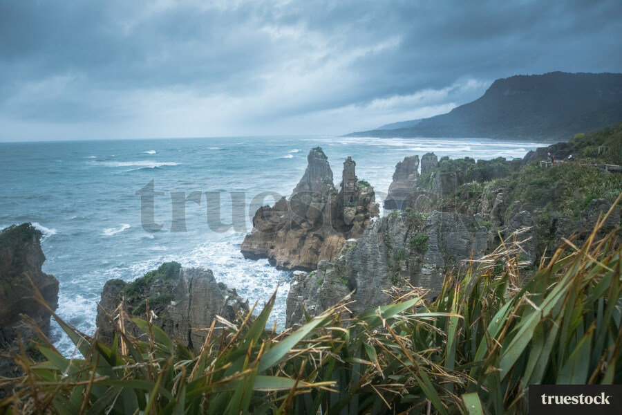 Landscape of rocky coast and ocean waves on an overcast day