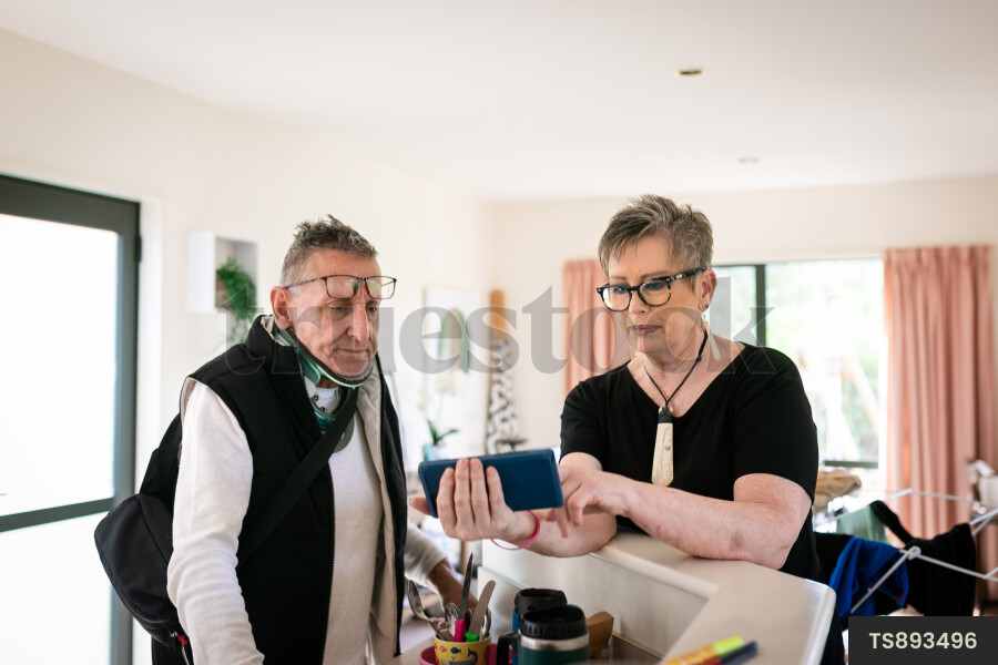 Health carer showing smart phone to patient