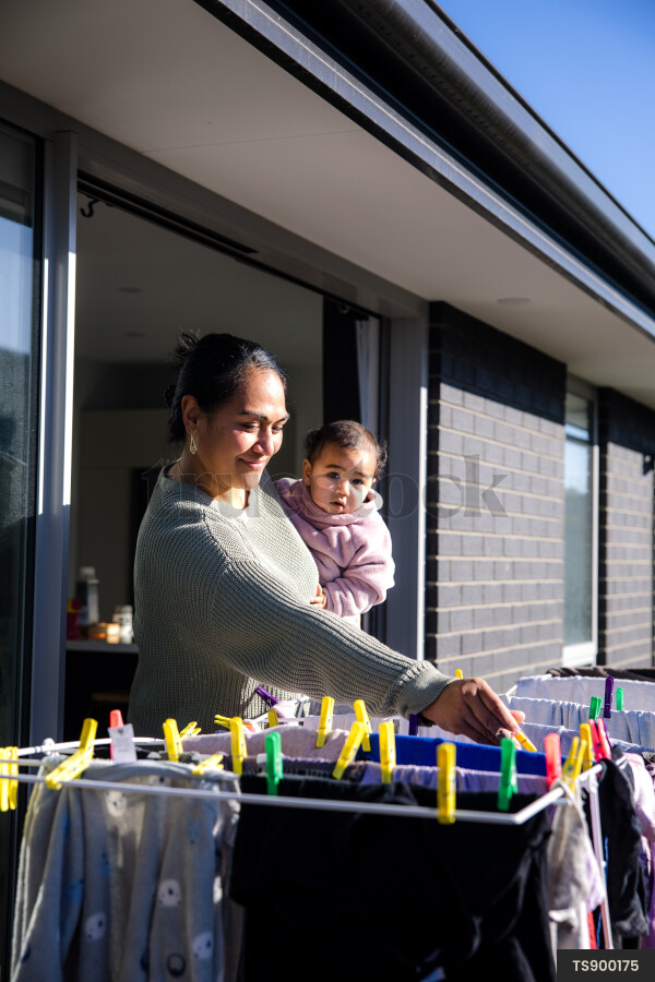 Woman doing laundry with her daughter