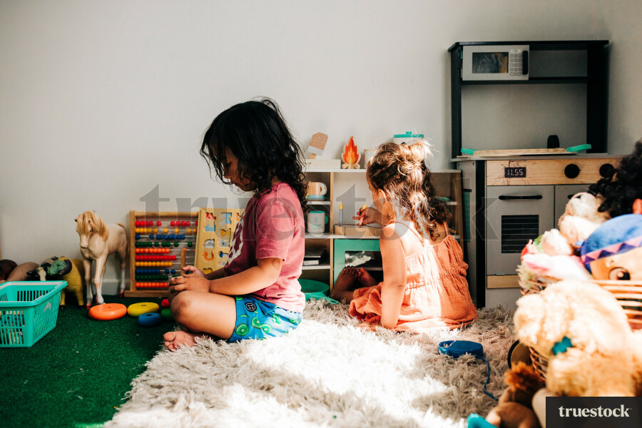 Māori boy playing on digital device in his room