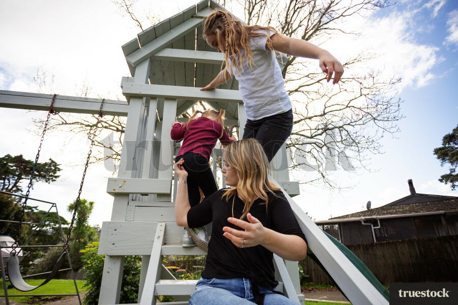 Mother and Daughters on Playground