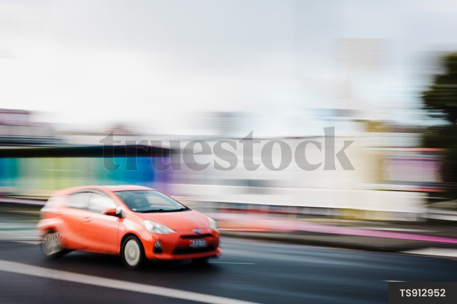 Long exposure of man driving car in street