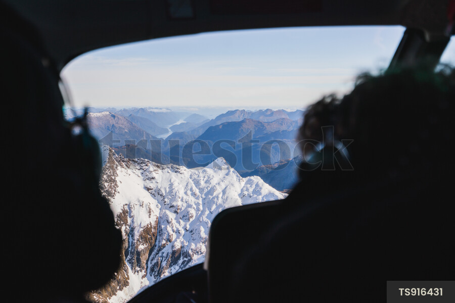 Men in helicopter above Fiordland National Park