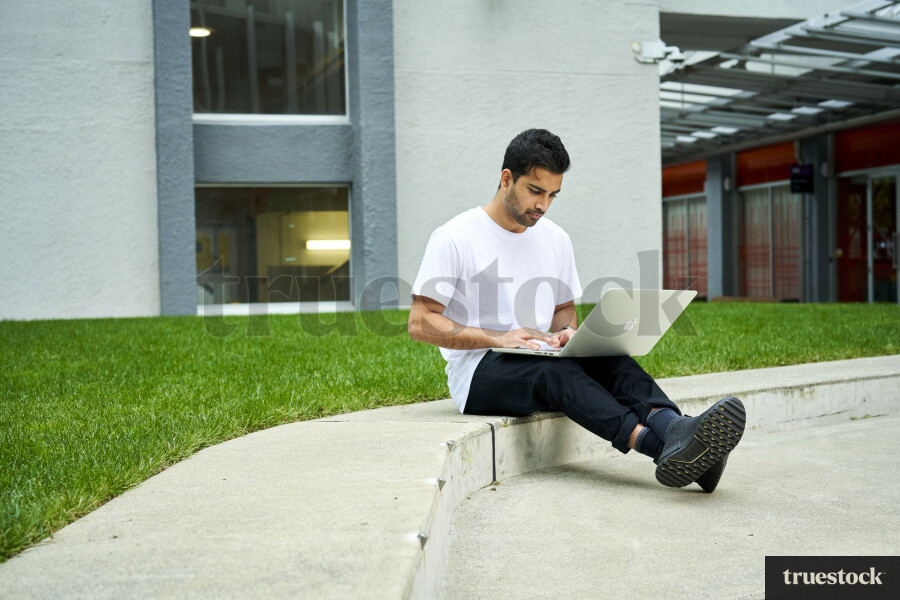 Student Using Laptop on Campus