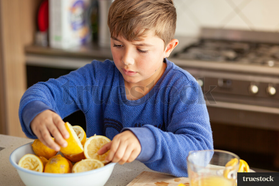 Young children making lemondade