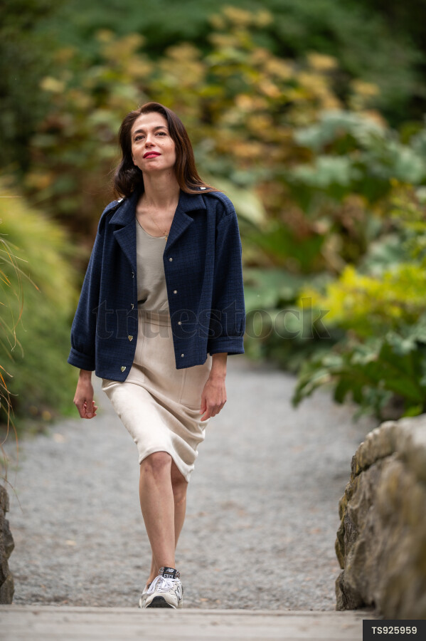 Woman with blue jacket in park