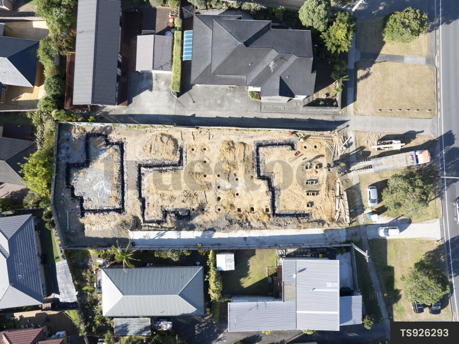 Aerial view of construction site between houses