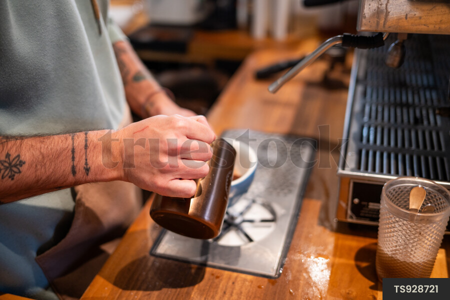 Barista making coffee in cafe
