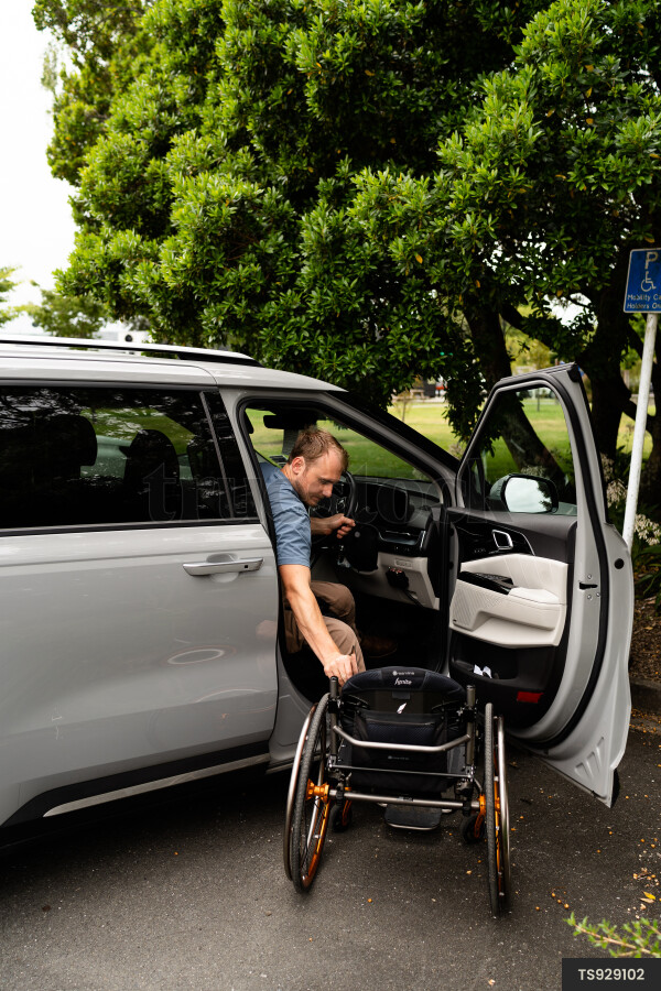 Man with wheelchair in car