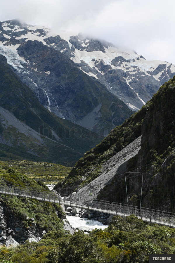 Landscape of bridge over river next to mountain