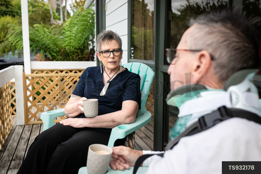 Health carer sitting with patient on deck