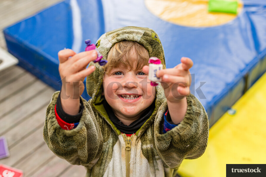 Toddler holding lollies