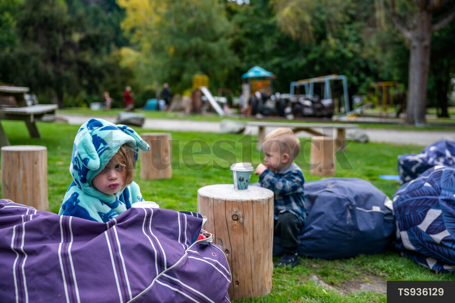 Children sitting on bean bags in park