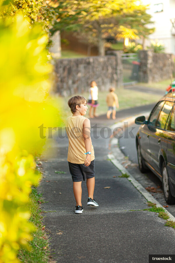 Children walking on the sidewalk in suburban area
