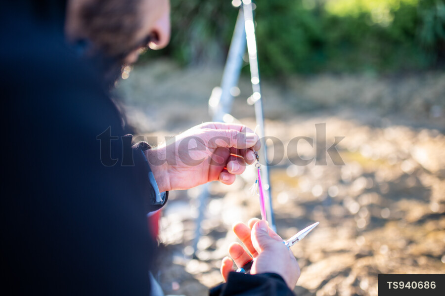Man Setting up Rod for Fishing