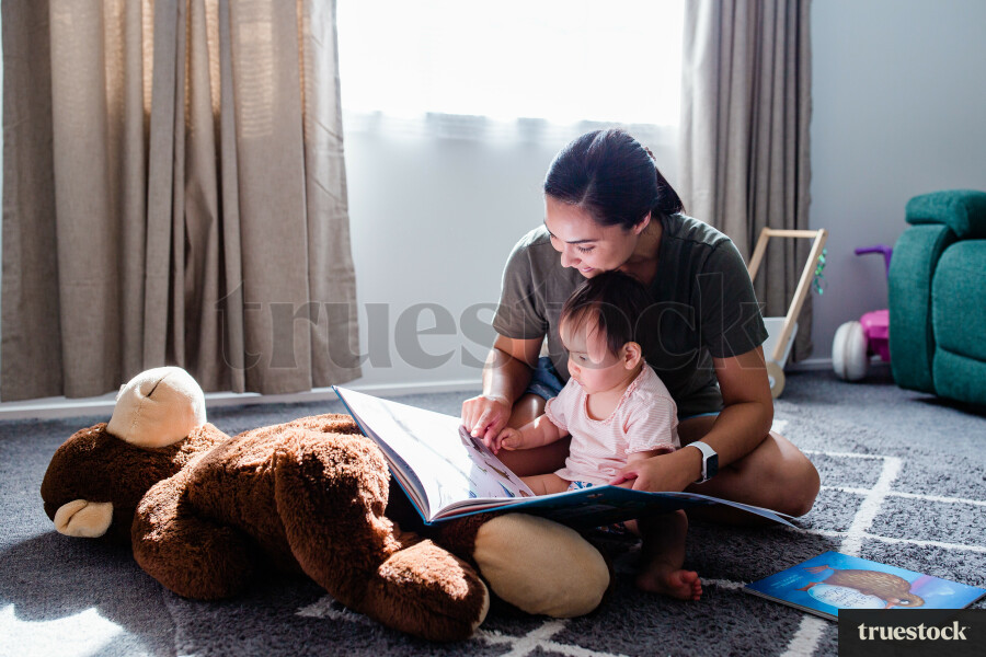Maori mother reading with child