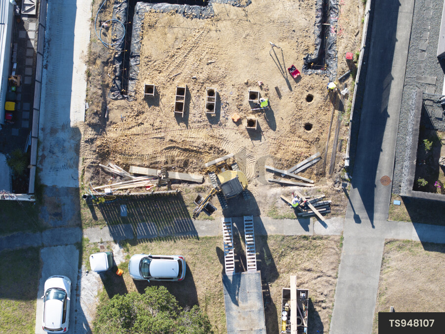 Construction site with digger and workers