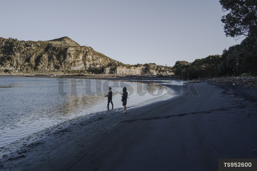 Boys fishing on beach